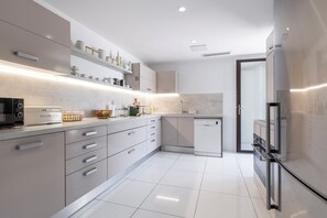A modern kitchen with a microwave, toaster, and refrigerator. - Exclusive Riviera Villa for 16 Guests | Pool & Ocean View (Saint-Jean-Cap-Ferrat)