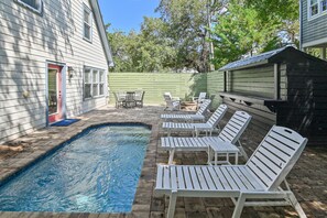 A backyard with a swimming pool, lounge chairs, and a patio table. - Adorable Old Seagrove Beach Cottage Bordering Seaside Near Beach Access (Santa Rosa Beach)