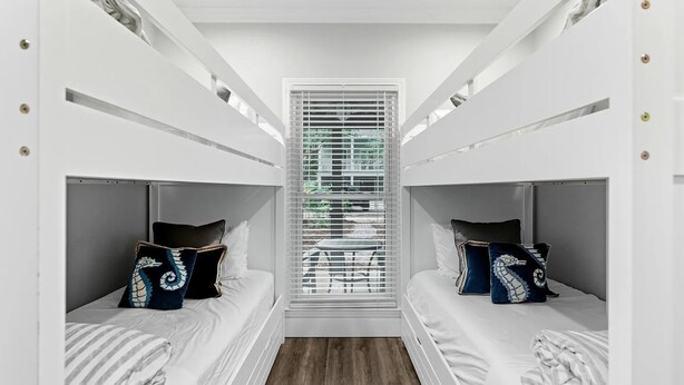 A room with bunk beds, a window with blinds, and a view of greenery outside. - Adorable Old Seagrove Beach Cottage Bordering Seaside Near Beach Access (Santa Rosa Beach)