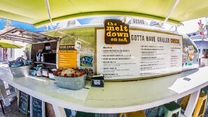 A food cart with a menu titled "GOTTA HAVE GRILLED CHEESE" and a sign that says "the melt down on 80A". - Adorable Old Seagrove Beach Cottage Bordering Seaside Near Beach Access (Santa Rosa Beach)