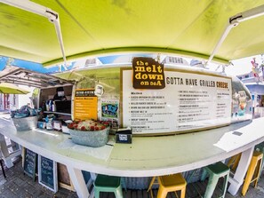 A food cart with a menu titled "GOTTA HAVE GRILLED CHEESE" and a sign that says "the melt down on 80A". - Adorable Old Seagrove Beach Cottage Bordering Seaside Near Beach Access (Santa Rosa Beach)
