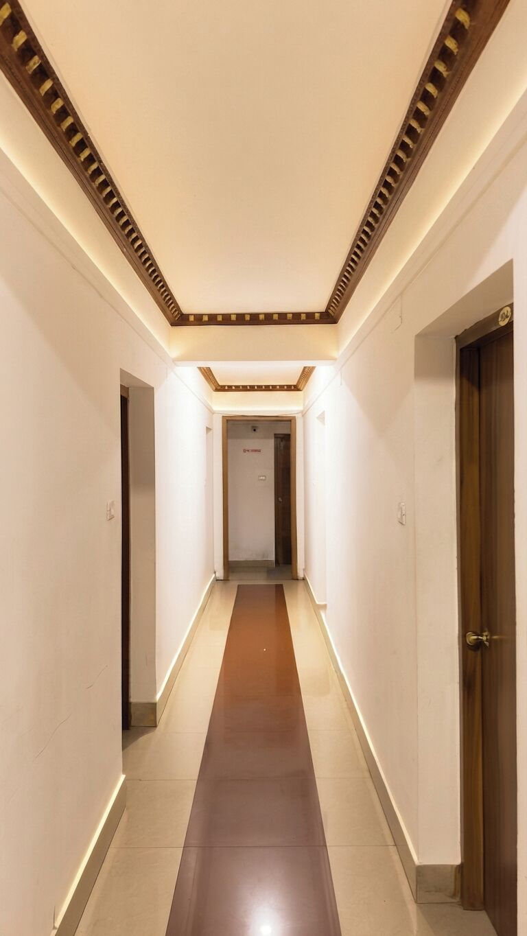 Un pasillo con techo de madera y una puerta a la derecha.