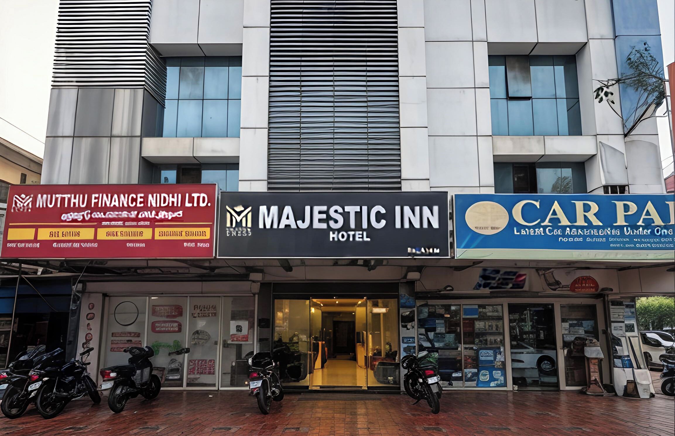 A building with multiple businesses including a finance company, a hotel, and a car dealership.