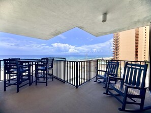 A balcony with a view of the ocean and a building. - Pelican Walk 612 Beachfront BLISS! 3Bedroom Condo (Panama City Beach)