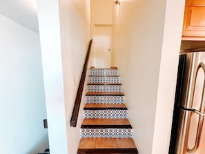 A staircase with patterned tiles and wooden steps leading to a door. - Peaceful Getaway w/ Beautiful Marina Views (Palmas del Mar)