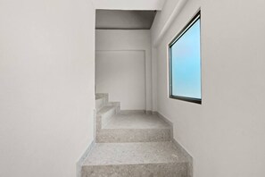 A staircase leading to a door with a window on the right. - Costa Brava Apt 4 | Calle Loiza 3/3 Apt @ San Juan (San Juan de Puerto Rico)
