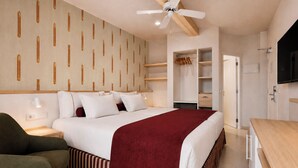 A hotel room with a bed, a desk, a chair, a wardrobe, and a ceiling fan. - Aura By Aubamar (Palma de Mallorca)