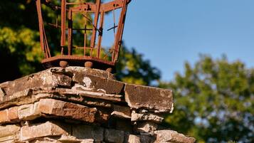 A weathered metal structure atop a stone wall.