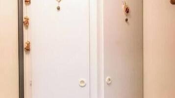 A white door with a heart-shaped decoration and a small keyhole.
