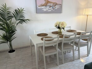 A dining area with a white table, woven placemats, and chairs. - 3 Bedroom Villa with Air Conditioning, Parking and Pool (Tías)