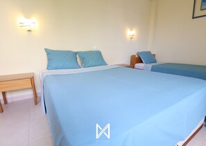 A hotel room with two beds, a nightstand, and wall-mounted lights. - MyStay - Apartment in Alvor with a pool (Alvor)
