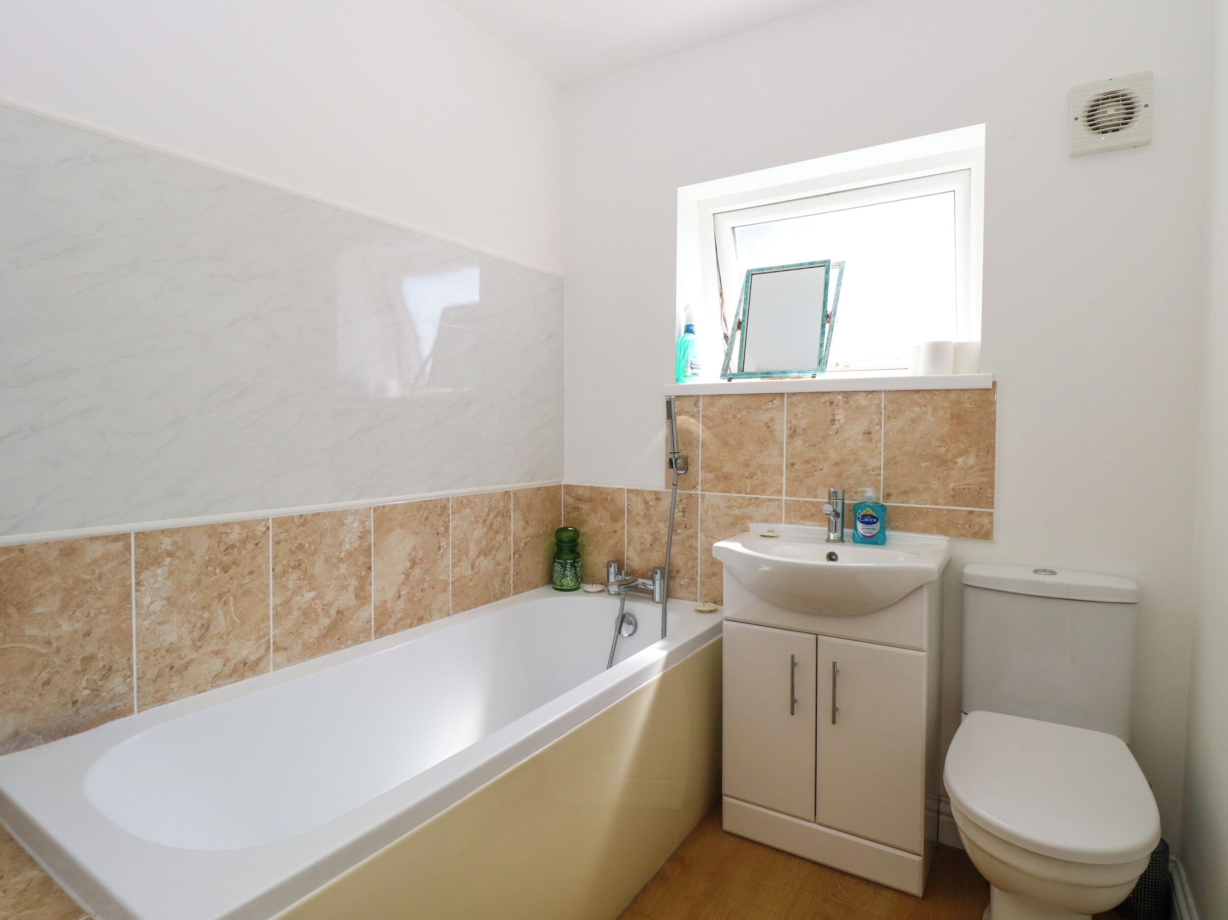 A bathroom with a bathtub, a sink, and a toilet.