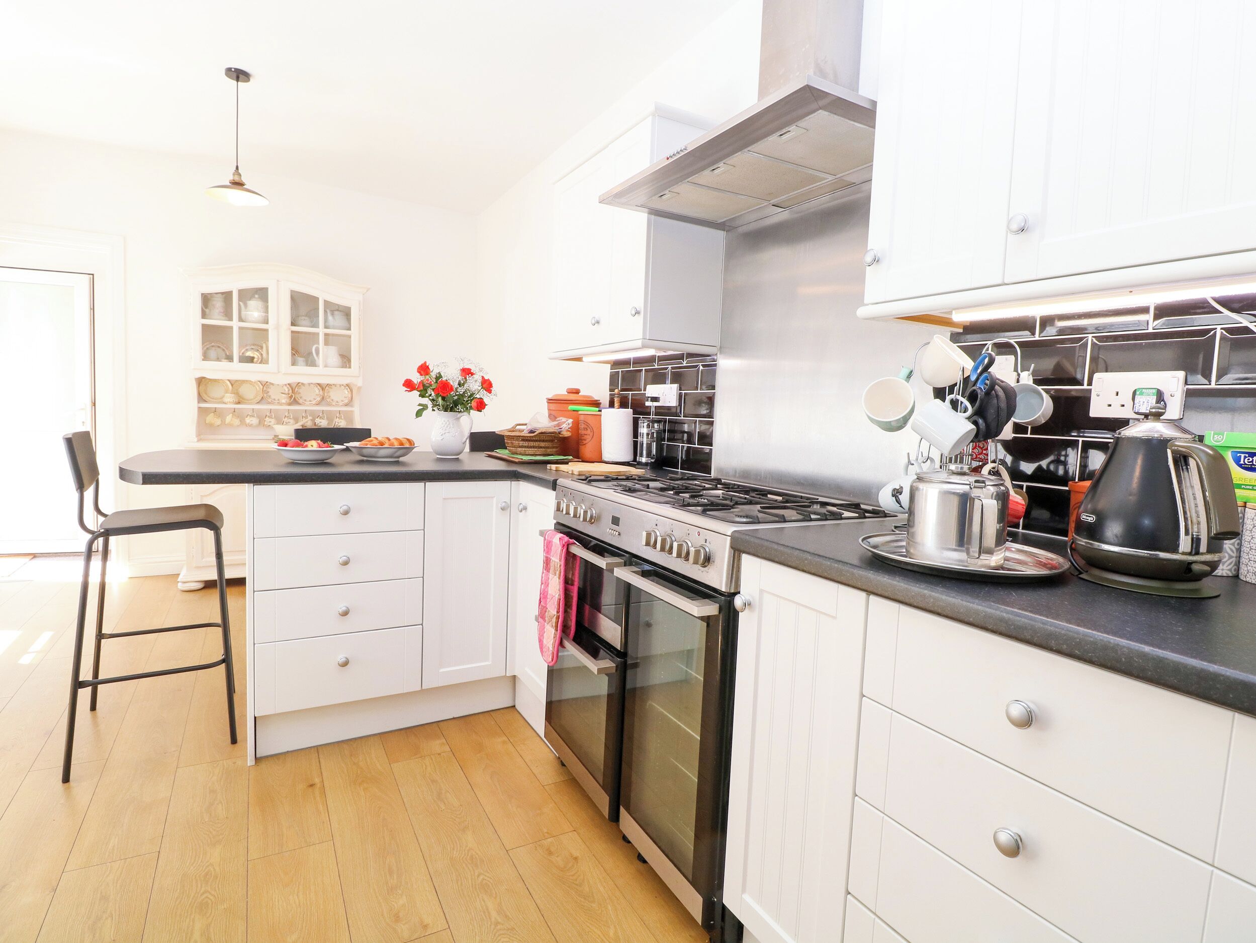 A kitchen with a stove, oven, and cabinets.