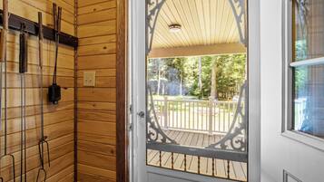 Un intérieur en bois avec une porte donnant sur une terrasse extérieure.