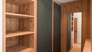Ein Holzinnenraum mit eingebauten Regalen und einer dunklen Wandverkleidung.