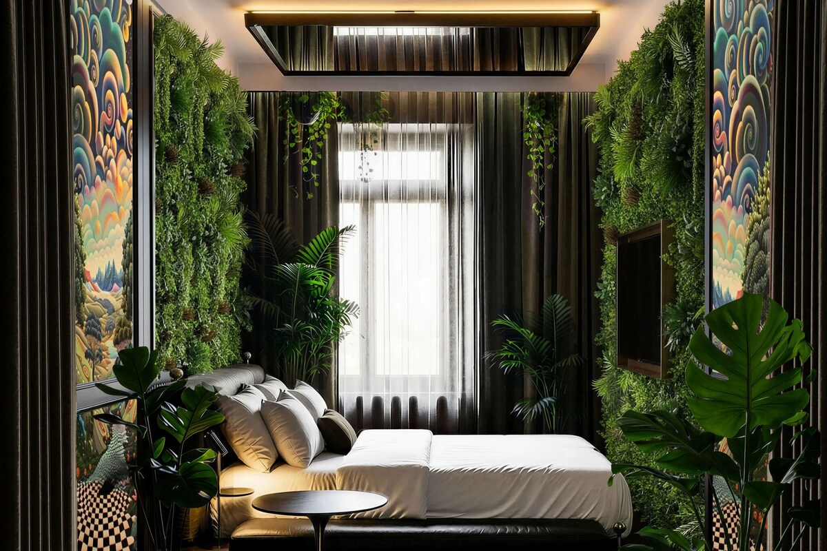 A modern bedroom with a bed, a round table, and a large window with curtains.