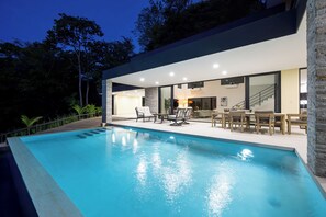 A modern house with a swimming pool, outdoor seating, and a staircase leading to an upper level. - New Listing • Casa Azul Oasis • Pacifico 4BR Villa • Private Pool (Playas del Coco)