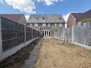 A residential property with a brick house, a wooden fence, and a clear sky. - Modern 3BDR Family House in North Stifford (North Stifford)