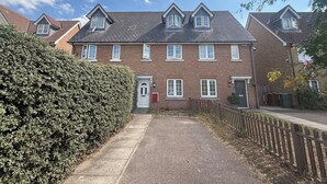 A two-story brick house with a front door, windows, and a paved driveway. - Modern 3BDR Family House in North Stifford (North Stifford)