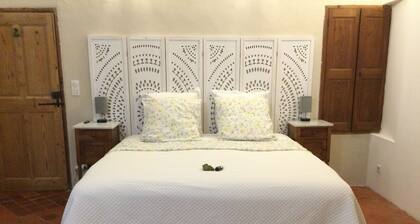 Stay at the estate in a green setting with an outdoor lounge area—treatments available