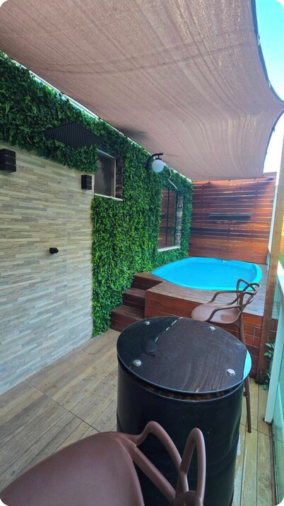 Apartment with hot tub, heater, and dry sauna.
