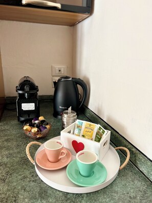 A kitchenette with a coffee maker, kettle, and tea packets on the counter. - Casa Gabry Verona | Ideal for families and groups (Verona)