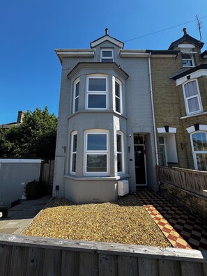 A two-story house with a bay window, a front door, and a small porch area. - Parley House , Cowes walk to Harbour Restaurants and Cafes (Cowes)