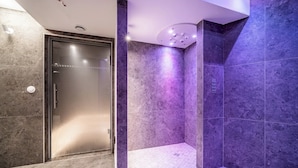 A modern bathroom with a glass shower enclosure, marble walls, and a tiled floor. - Altis - Terrace | Spa | Ski locker | Alpe d'Huez (Huez)