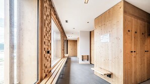 A hallway with wooden benches, a large wooden wardrobe, and a window with a view. - Altis - Terrace | Spa | Ski locker | Alpe d'Huez (Huez)