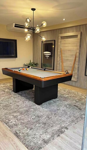 A pool table with balls, a ceiling light fixture, and a potted plant. - 2-bedroom apartment w/ sunset view - Pool - Gym, beautiful Barranco y Miraflores (Lima)