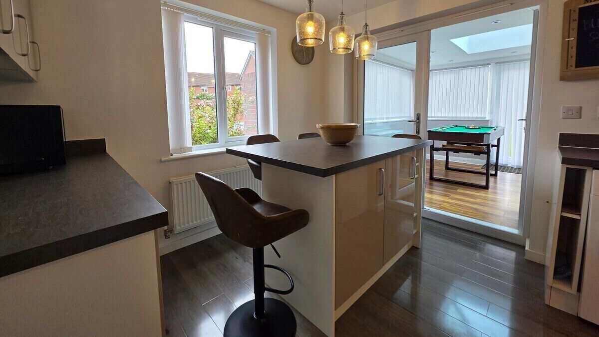 Gather around the island for morning coffee or evening cocktails. Seating for four makes this the heart of the home.