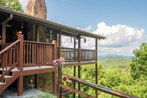 A wooden cabin with a balcony overlooking a forested landscape. - Full Arcade Game Room, Hot Tub & Mountain Views, Sleeps 10 Near Dollywood (Sevierville)