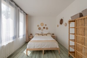 A bedroom with a bed, bedside tables, a wooden wardrobe, and wall decorations. - Le Beau Rivage - 1km de la Plage (Criel-sur-Mer)