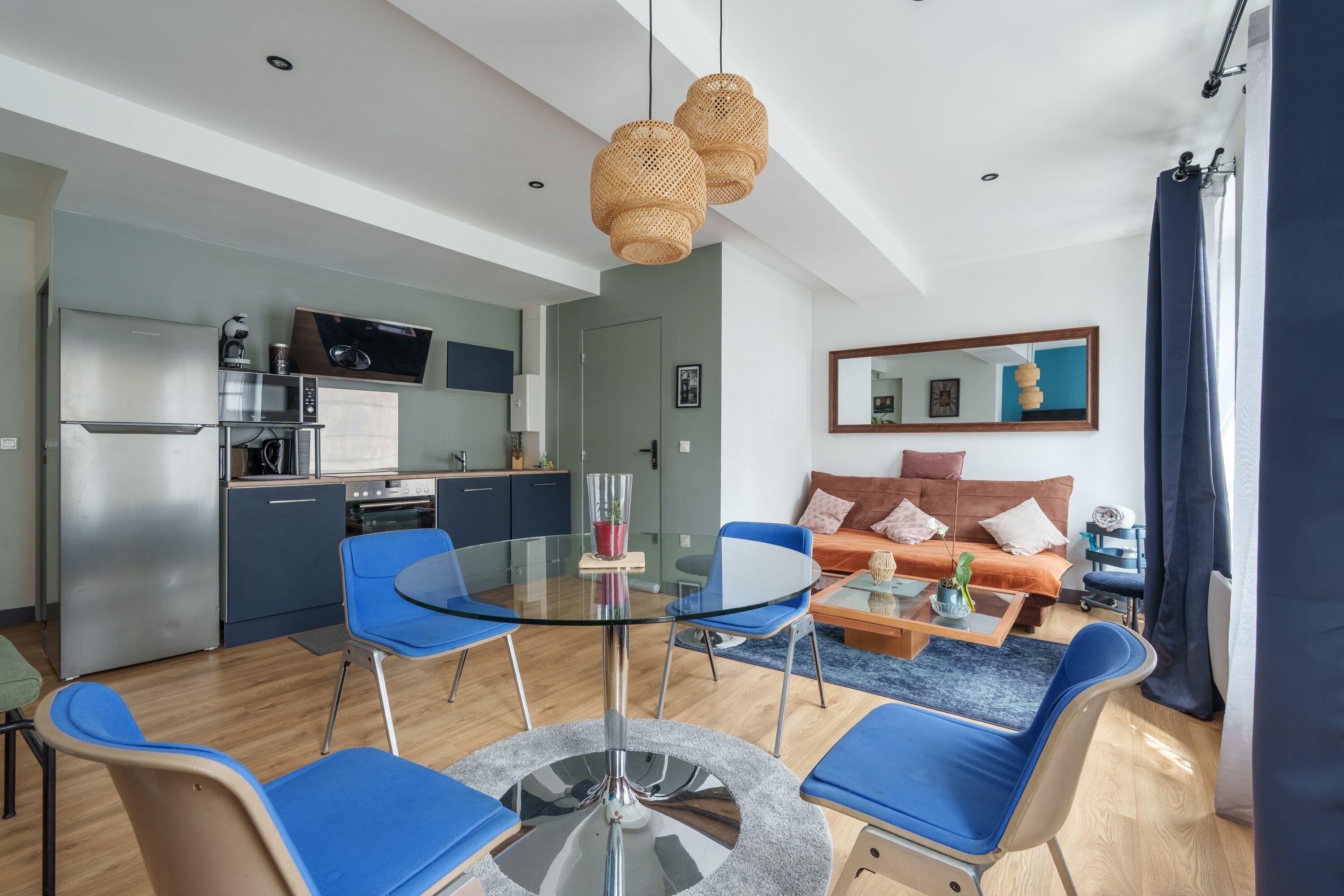 A modern living space with a kitchen, dining area, and seating area.