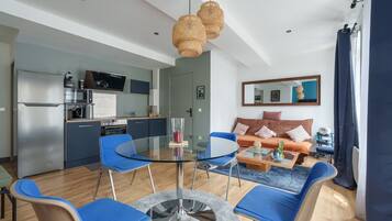 A modern living space with a kitchen, dining area, and seating area.