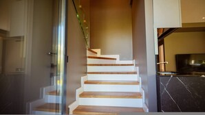 A modern staircase with wooden steps and glass railings. - Villa with Pool | San Pietro Resort (Durrës)