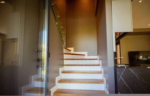 A modern staircase with wooden steps and glass railings. - Villa with Pool | San Pietro Resort (Durrës)