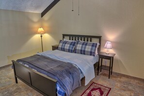 A bedroom with a bed, two bedside tables, a lamp, and a rug. - Longbranch 309 in Breckenridge (Breckenridge)