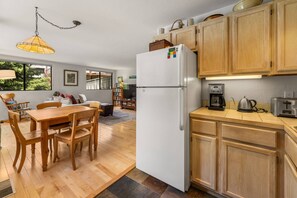 A compact kitchen with wooden cabinets, a white refrigerator, a coffee maker, and a toaster. - New Listing! Budget Friendly, Prime Location, Private Deck (Telluride)