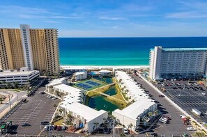 A hotel complex with multiple high-rise buildings, a parking area, and a pool. - BEACHFRONT COMPLEX, 2nd-Floor, park next to unit, steps to pool/wide open beach (Panama City Beach)