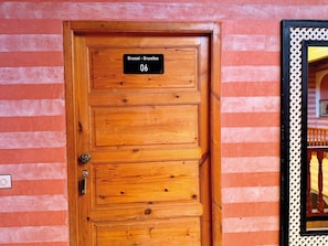 A wooden door with a sign indicating room number 06, a keyhole, and a lock. - Riad Belgika (Ourika)