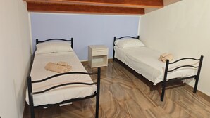 A room with two single beds, a small bedside table, and a wooden ceiling. - Apartment 'Dea' with Shared Pool, Wi-Fi, and Air Conditioning (Arenella)