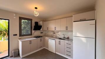 Apartment | Private kitchen | Fridge, dining tables