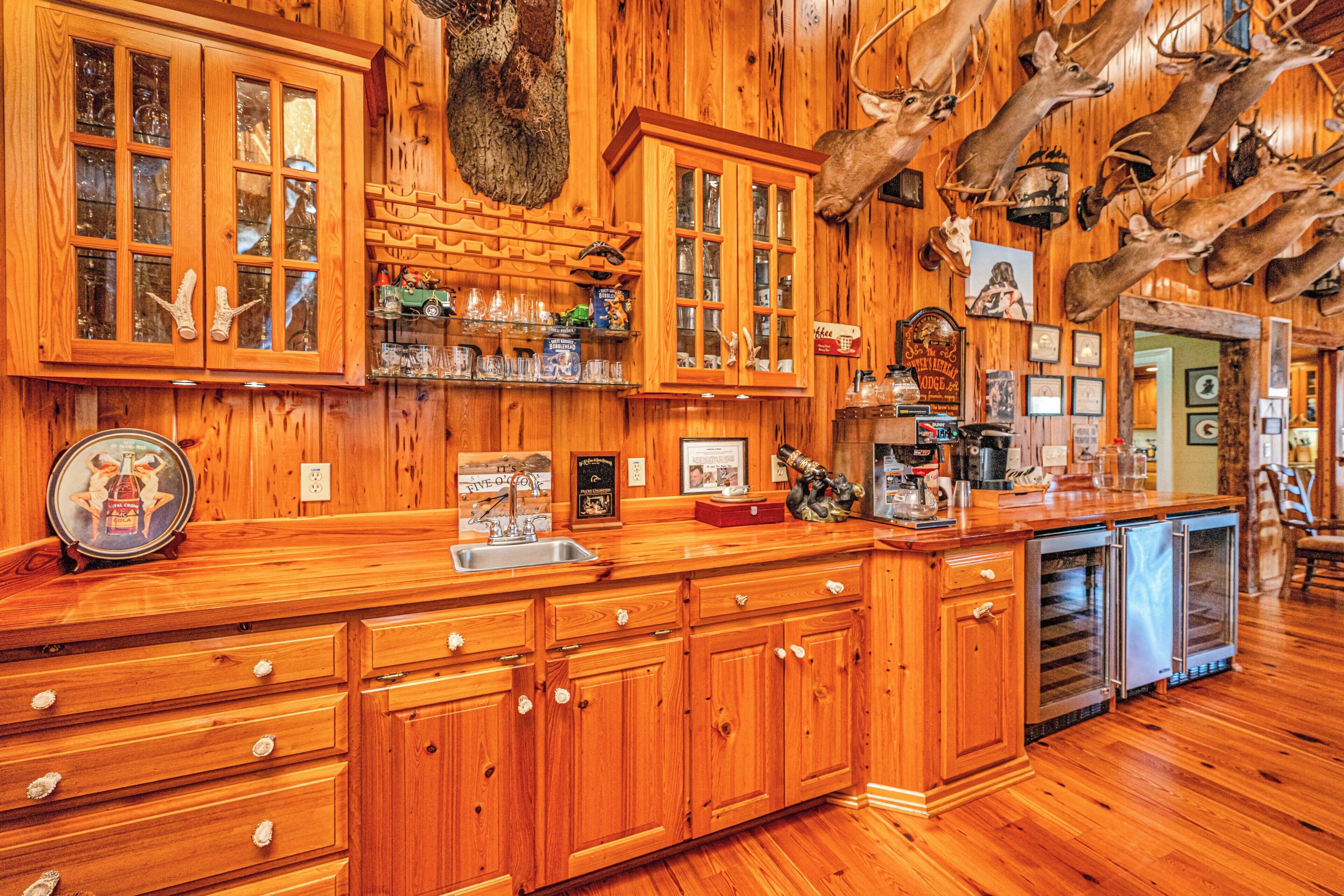 A wooden interior with cabinets, a sink, and a refrigerator.