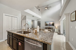 A spacious kitchen with granite countertops, a stainless steel sink, and a dishwasher. - 5BR Pool Home-Spa-Epic Game Room Near Disney (Davenport)