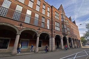 A historic building with multiple arches and a brick facade.
