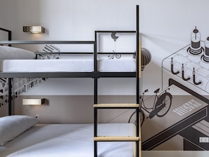 A bunk bed room with a ladder, a bicycle wall art, and a wall-mounted light fixture. - Stayokay Hostel Groningen (Groningen)