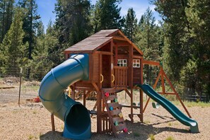 A wooden play structure with a slide and climbing elements. - South of Sunriver - Near Mt Bachelor - Hot Tub (Bend)
