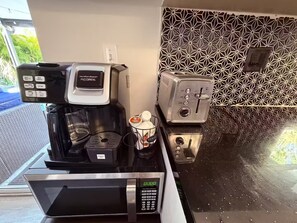 A kitchen with a coffee maker, toaster, and microwave. - Guest Favorite! Tropical Oasis / Luxury Pool (Largo)
