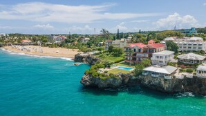 A coastal hotel with a pool, beach access, and a view of the ocean. - Stylish 3BR Penthouse Ocean Views, Sosúa Center (Sosúa)
